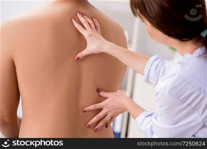 Young female doctor chiropractor massaging male patient. The young female doctor chiropractor massaging male patient