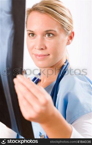 Young female doctor examining x-ray isolated on white background