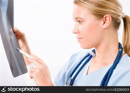 Young female doctor examining x-ray isolated on white background