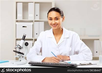 Young female doctor in white uniform at workplace