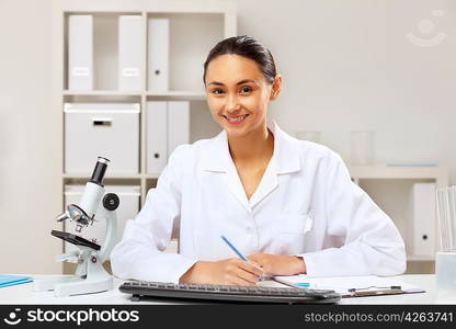 Young female doctor in white uniform at workplace