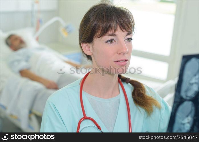 young female doctor looking at x-ray