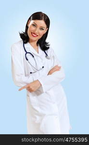 young female doctor portrait. Portrait of happy successful young female doctor holding a stethoscope