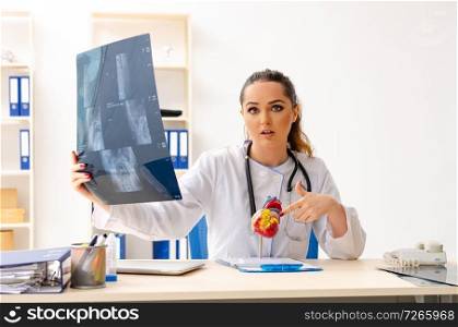 Young female doctor radiologist sitting at the clinic 