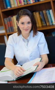 young female doctor studying in library