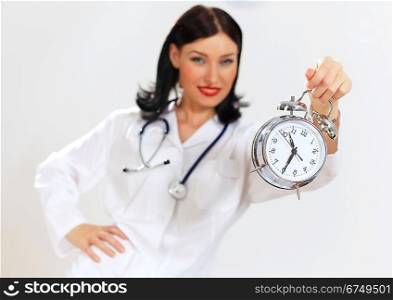 Young female doctor with clocks