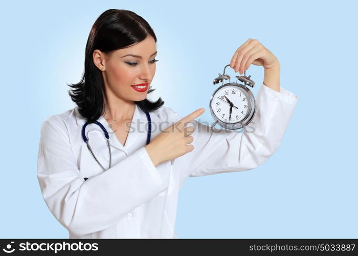 Young female doctor with clocks. Portrait of happy successful young female doctor holding clocks