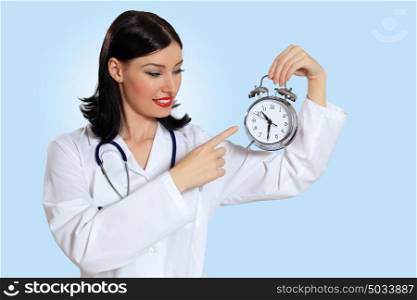 Young female doctor with clocks. Portrait of happy successful young female doctor holding clocks