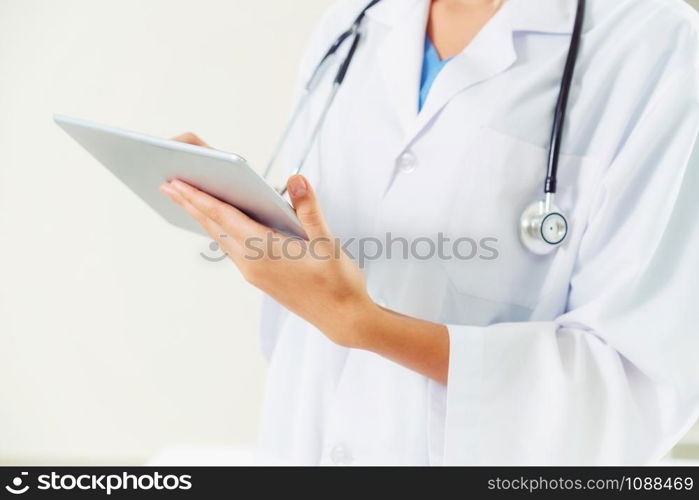Young female doctor working in hospital office. Medical and healthcare concept.