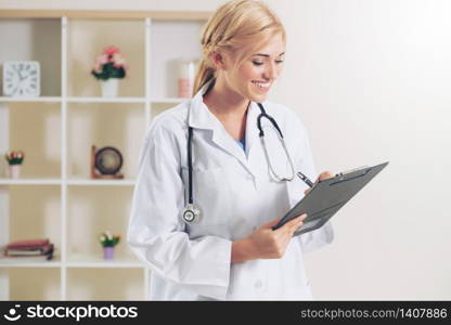 Young female doctor working in hospital office. Medical and healthcare concept.. Young female doctor working in hospital office.