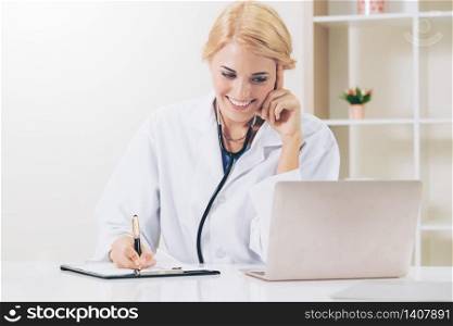 Young female doctor working in hospital office. Medical and healthcare concept.. Young female doctor working in hospital office.