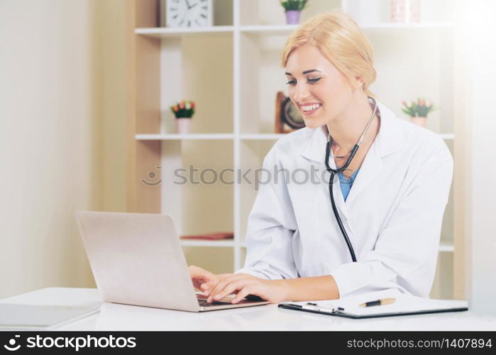 Young female doctor working in hospital office. Medical and healthcare concept.. Young female doctor working in hospital office.