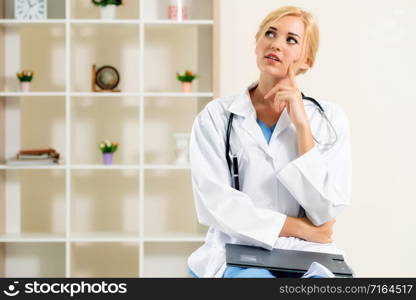 Young female doctor working in hospital office. Medical and healthcare concept.. Young female doctor working in hospital office.