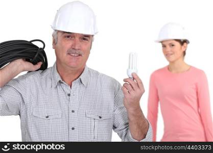 young female electrician with tutor