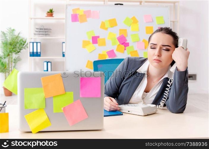 Young female employee in conflicting priorities concept 