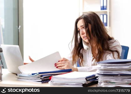 Young female employee unhappy with excessive work 