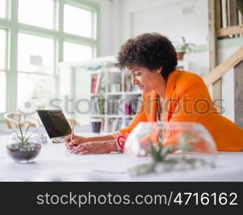 Young female engineer working in office. Getting your house plan ready