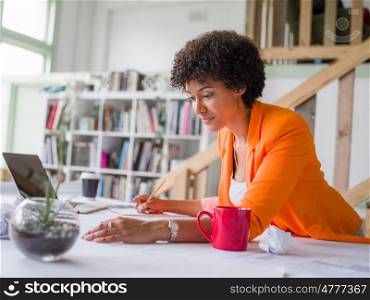 Young female engineer working in office. Getting your house plan ready