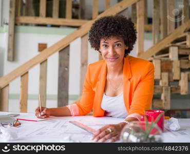 Young female engineer working in office. Getting your house plan ready