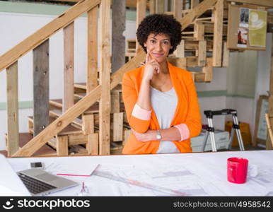 Young female engineer working in office. Getting your house plan ready