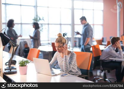 Young female Entrepreneur Freelancer Working Using A Laptop In Coworking space