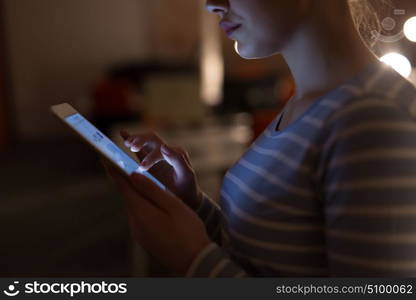 young female entrepreneur working on digital tablet in night office