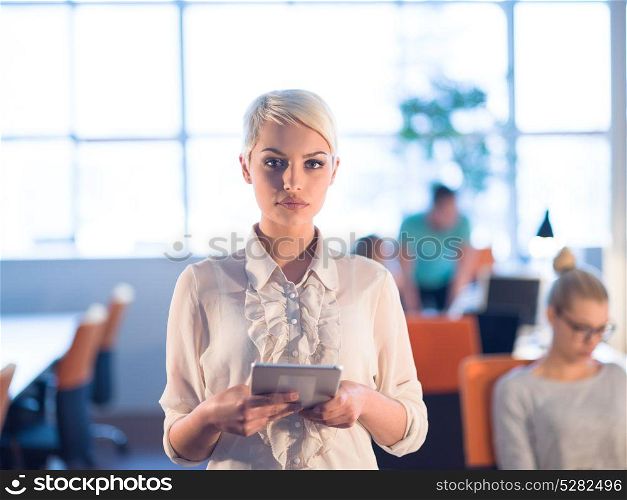young female entrepreneur working on digital tablet in night office