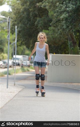 young female exercise outdoor on rollerblades