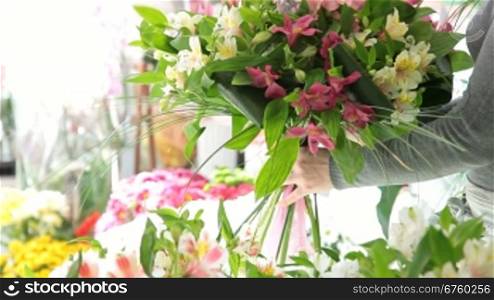 Young Female Florist Arranging Bouquet Of Alstroemeria In Her Store Closeup