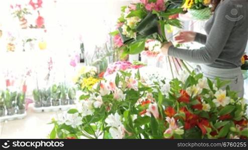 Young Female Florist Creating Bouquet Of Alstroemeria In Flower Shop