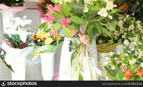 Young Female Florist Creating Flower Arrangement Of Alstroemeria In Her Store