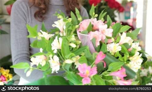 Young Female Florist Creating Flower Arrangement Of Alstroemeria In Her Store. Focus On The Bouquet