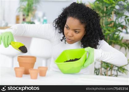 young female gardener replanting flowers