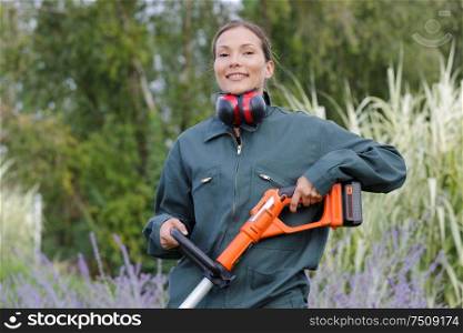 young female gardener with machine