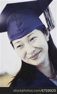 Young female graduate smiling