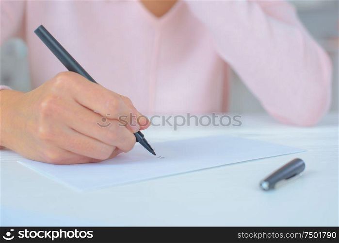young female is writing notes and planning her schedule