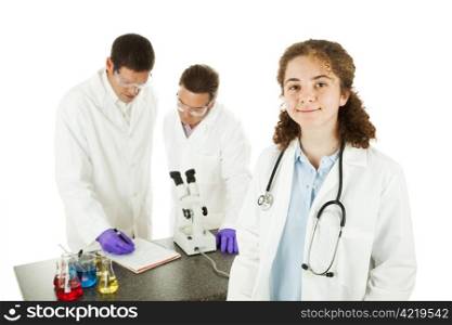 Young female medical student in the lab with scientists working in the background. Isolated on white.