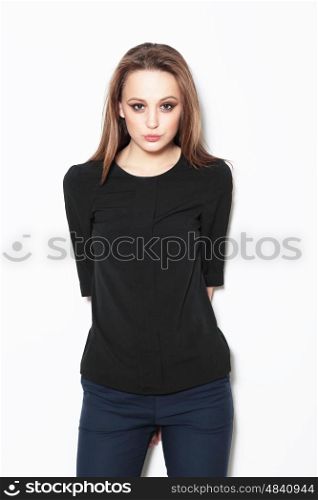 Young female model posing in the studio, fashion, looking into the camera.