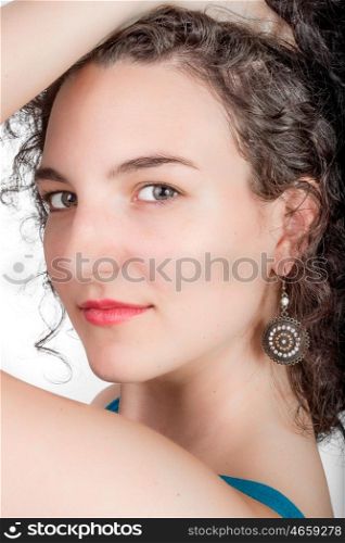 Young female model with black hair, blue open shoulder dress on a white background.