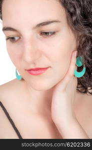 Young female model with open shoulder dress and aqua colored earrings of middel eastern design.