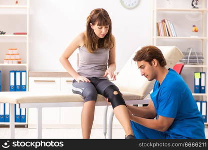 Young female patient visiting male doctor traumatologist 