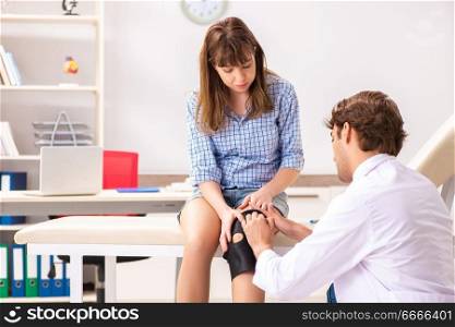 Young female patient visiting male doctor traumatologist 