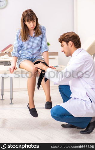 Young female patient visiting male doctor traumatologist . The young female patient visiting male doctor traumatologist 