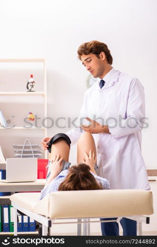 Young female patient visiting male doctor traumatologist . The young female patient visiting male doctor traumatologist 