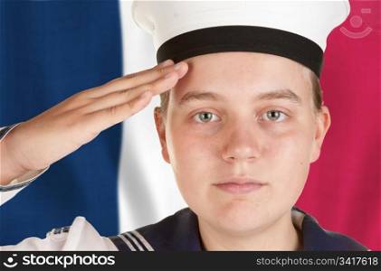 young female sailor saluting in front of french flag