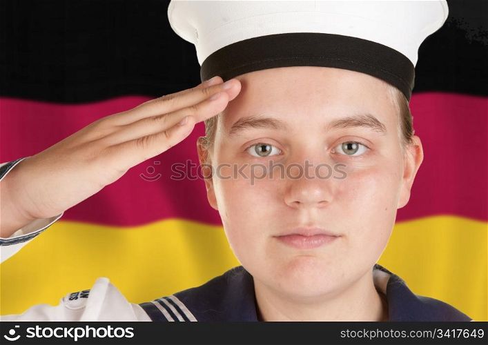 young female sailor saluting in front of german flag