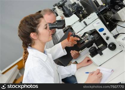 young female scientist doing chemical test in laboratory