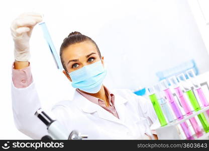 Young female scientist working with liquids in laboratory