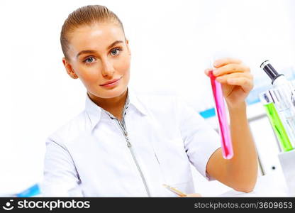 Young female scientist working with liquids in laboratory