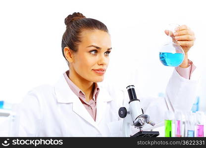 Young female scientist working with liquids in laboratory